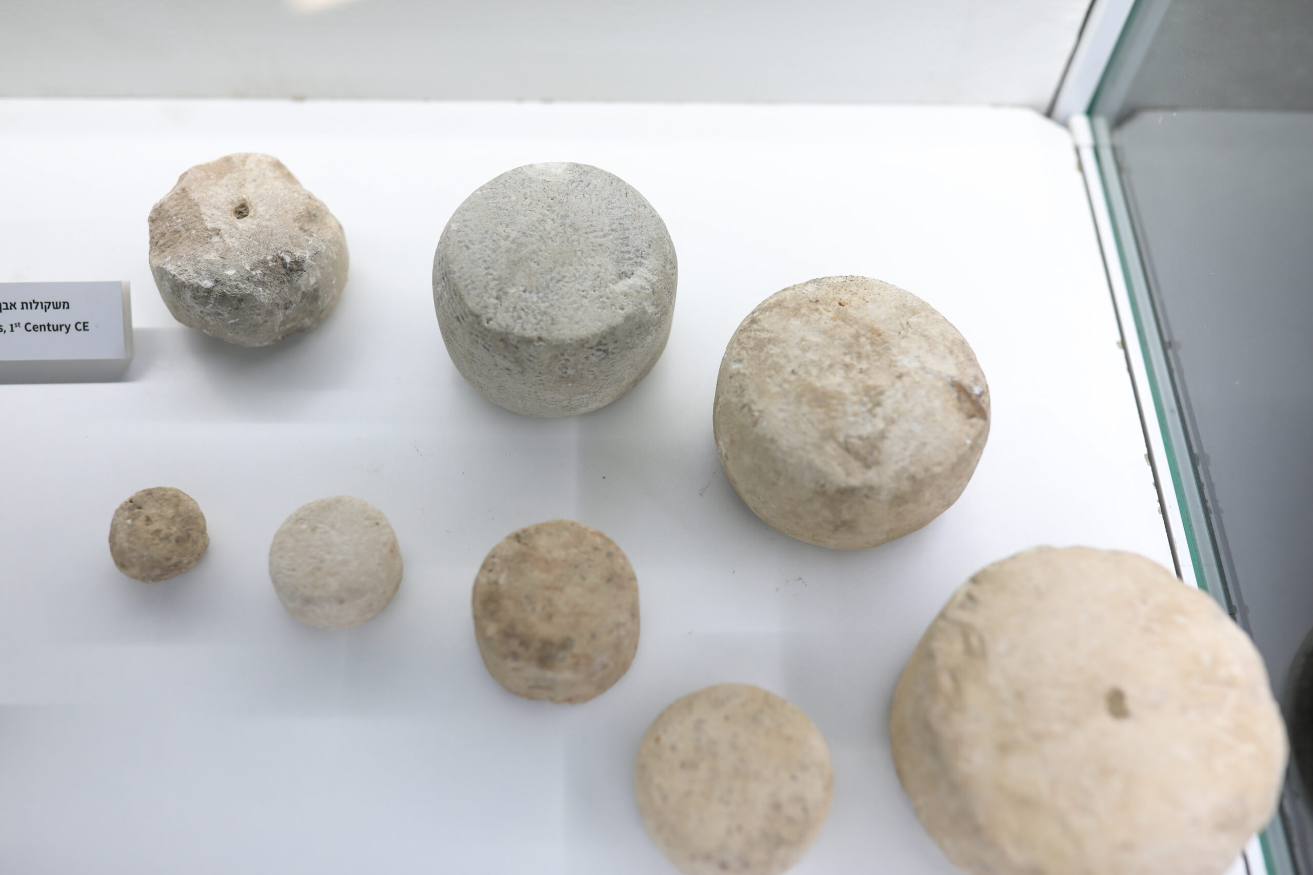 Stone weights discovered on the pilgrimage road. The inscription joins these findings attesting to the commercial nature of the area. Photo: Tomer Avital.